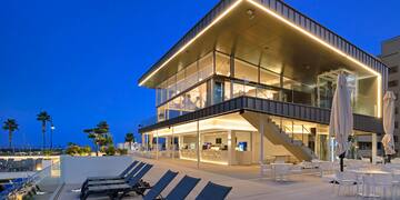 a building with chairs and a pool
