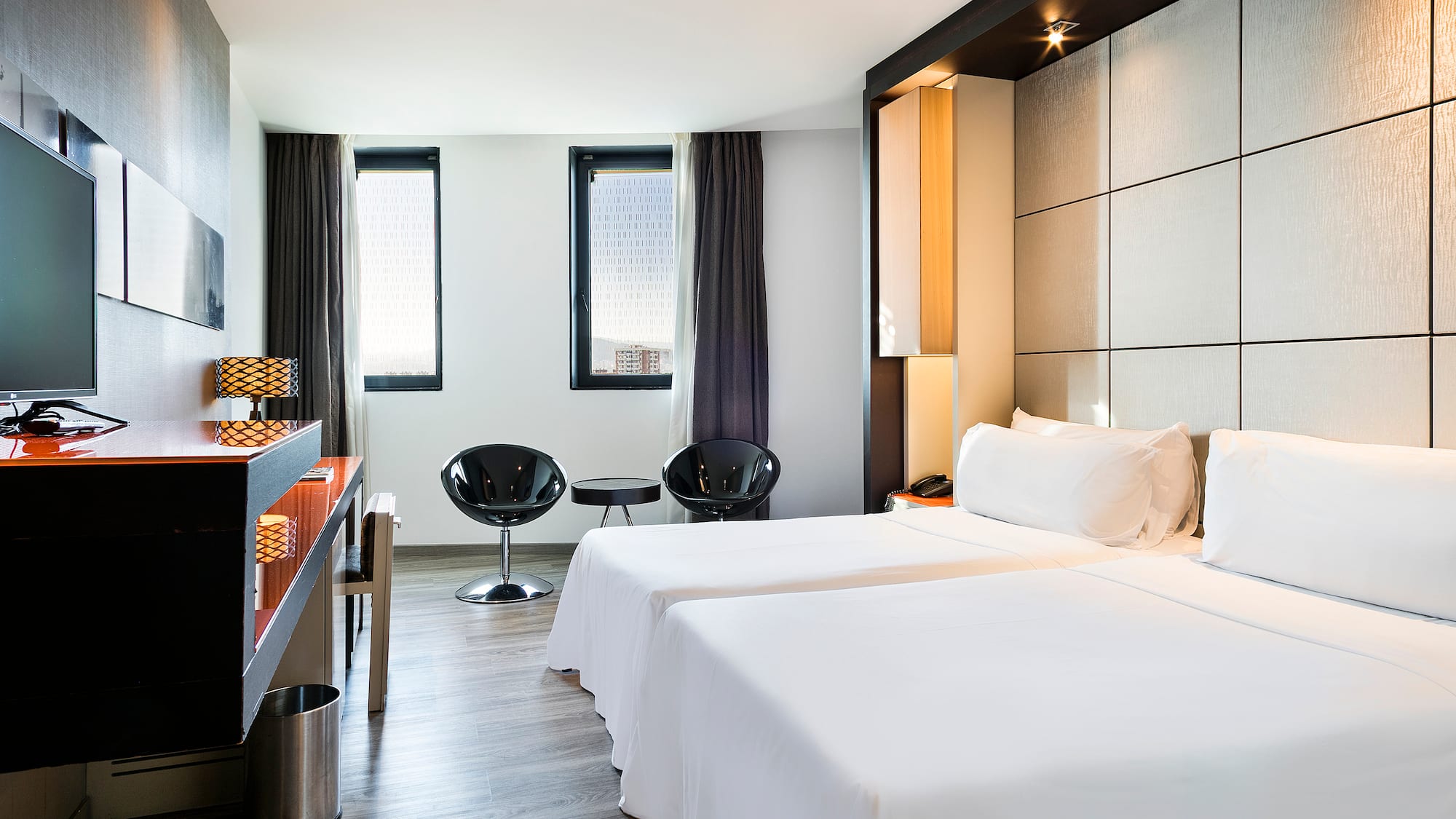 a room with two beds and a table