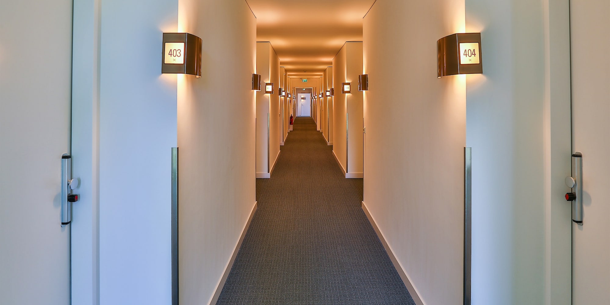 a long hallway with lights on