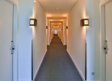 a long hallway with lights on