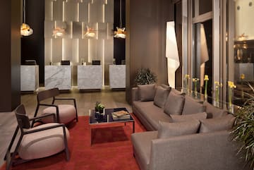 a room with a couch and chairs