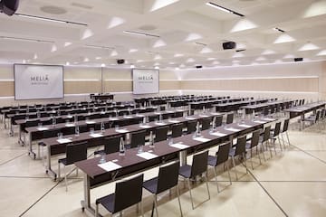 a large conference room with tables and chairs