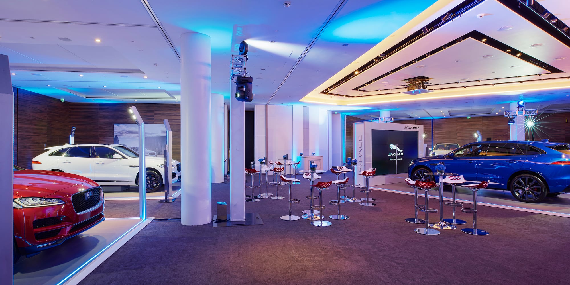 a room with stools and a car