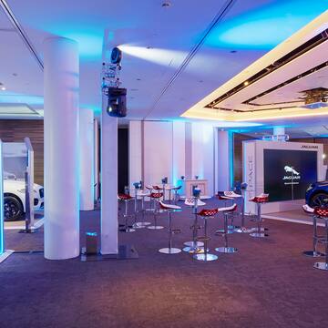 a room with stools and a car