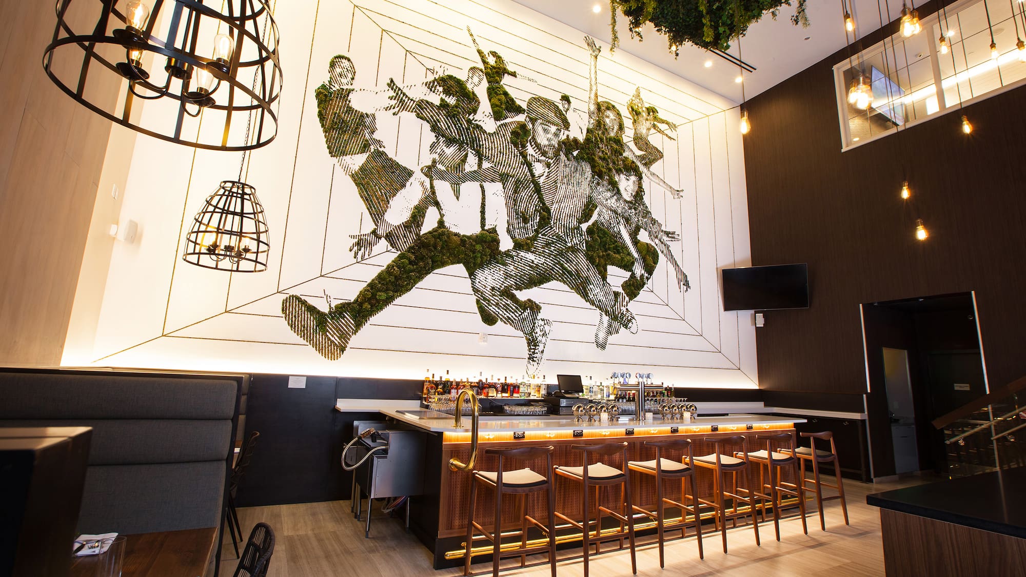 a bar with a painting on the wall