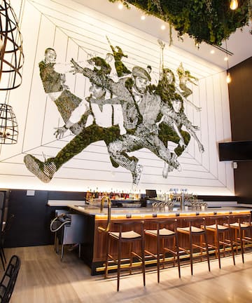 a bar with a painting on the wall