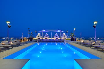 a pool with chairs and a tent on the side