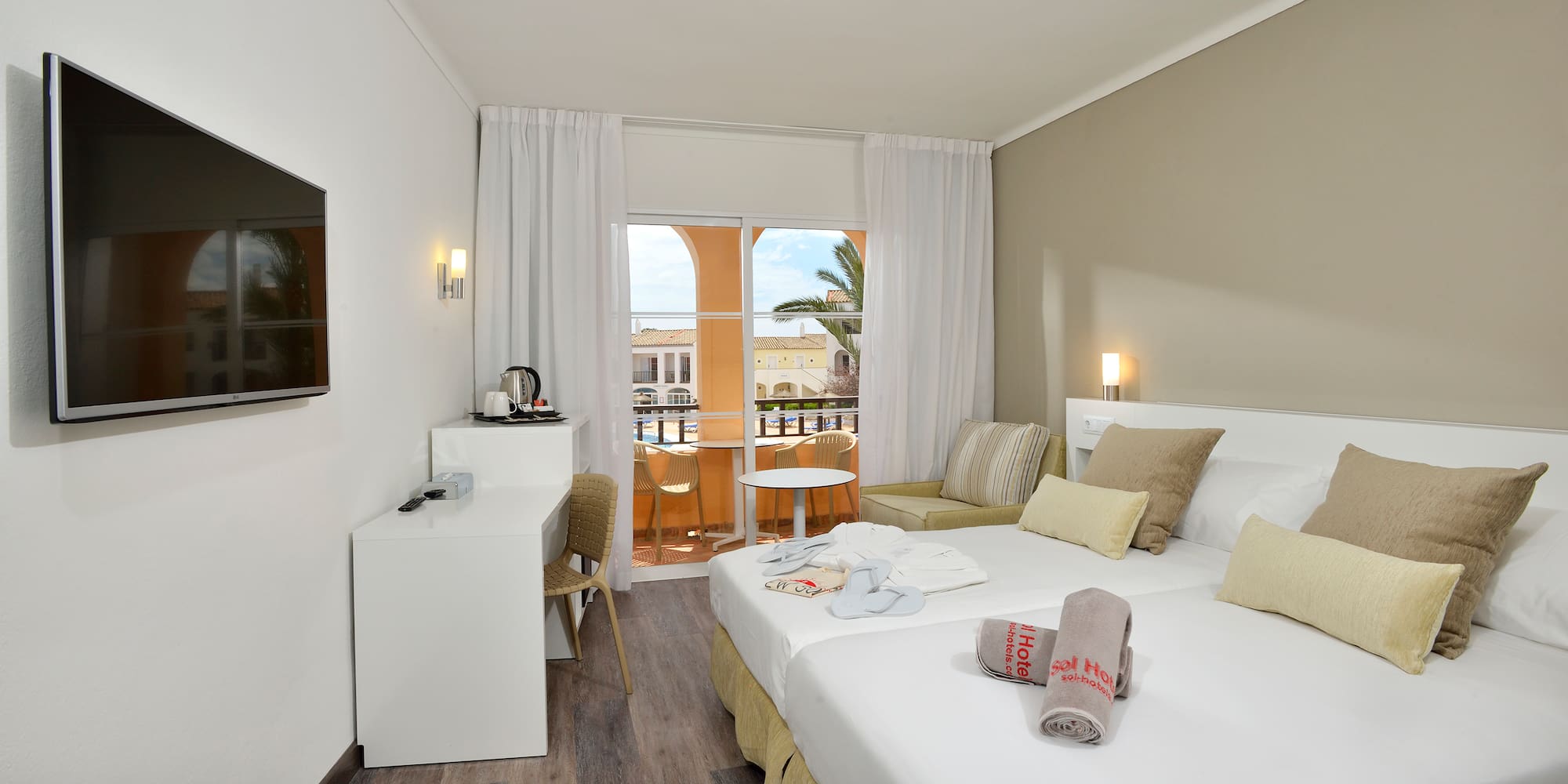 a room with two beds and a table