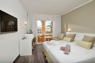a room with two beds and a table
