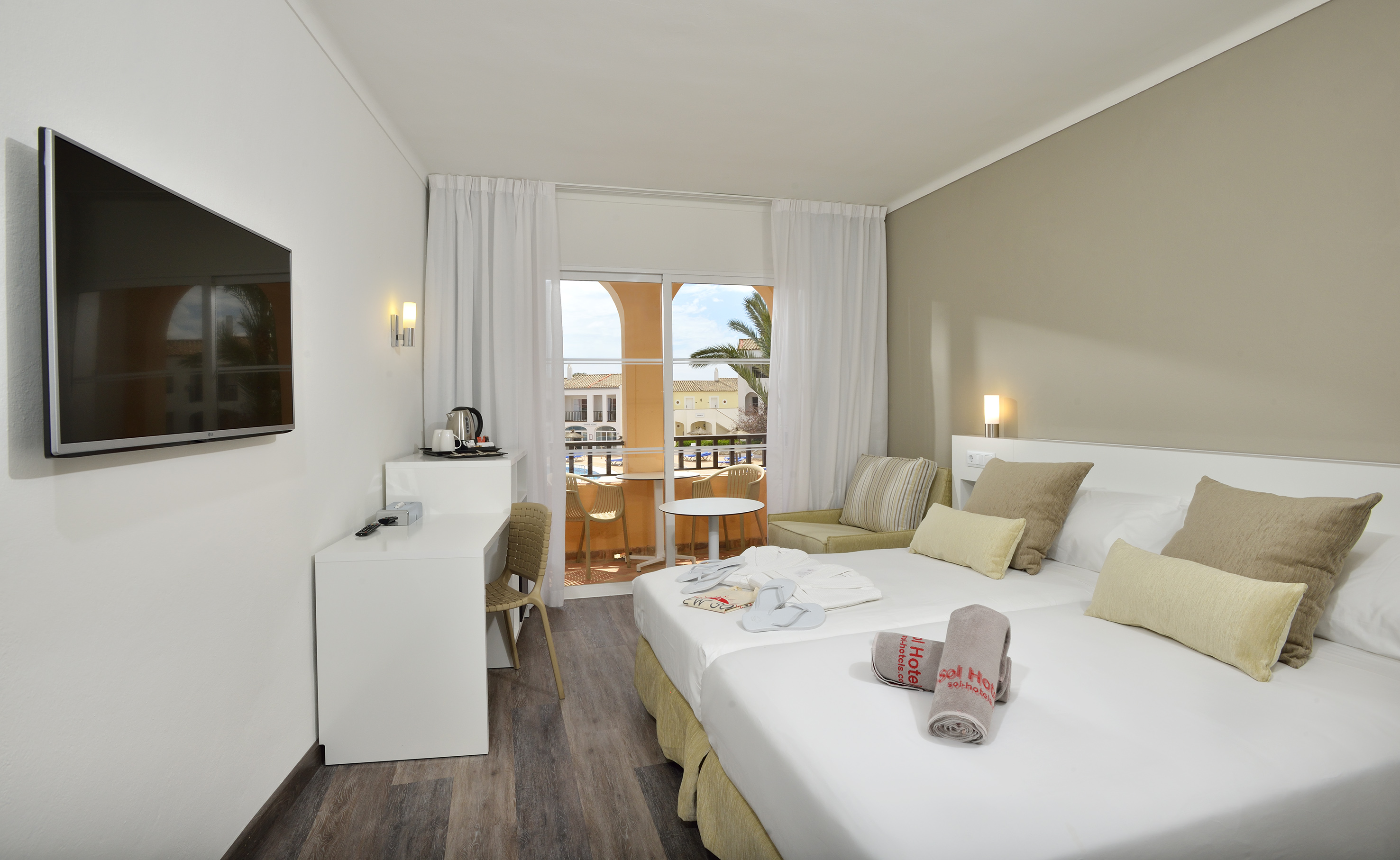 a room with two beds and a table