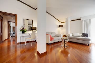 a room with white furniture and a wood floor