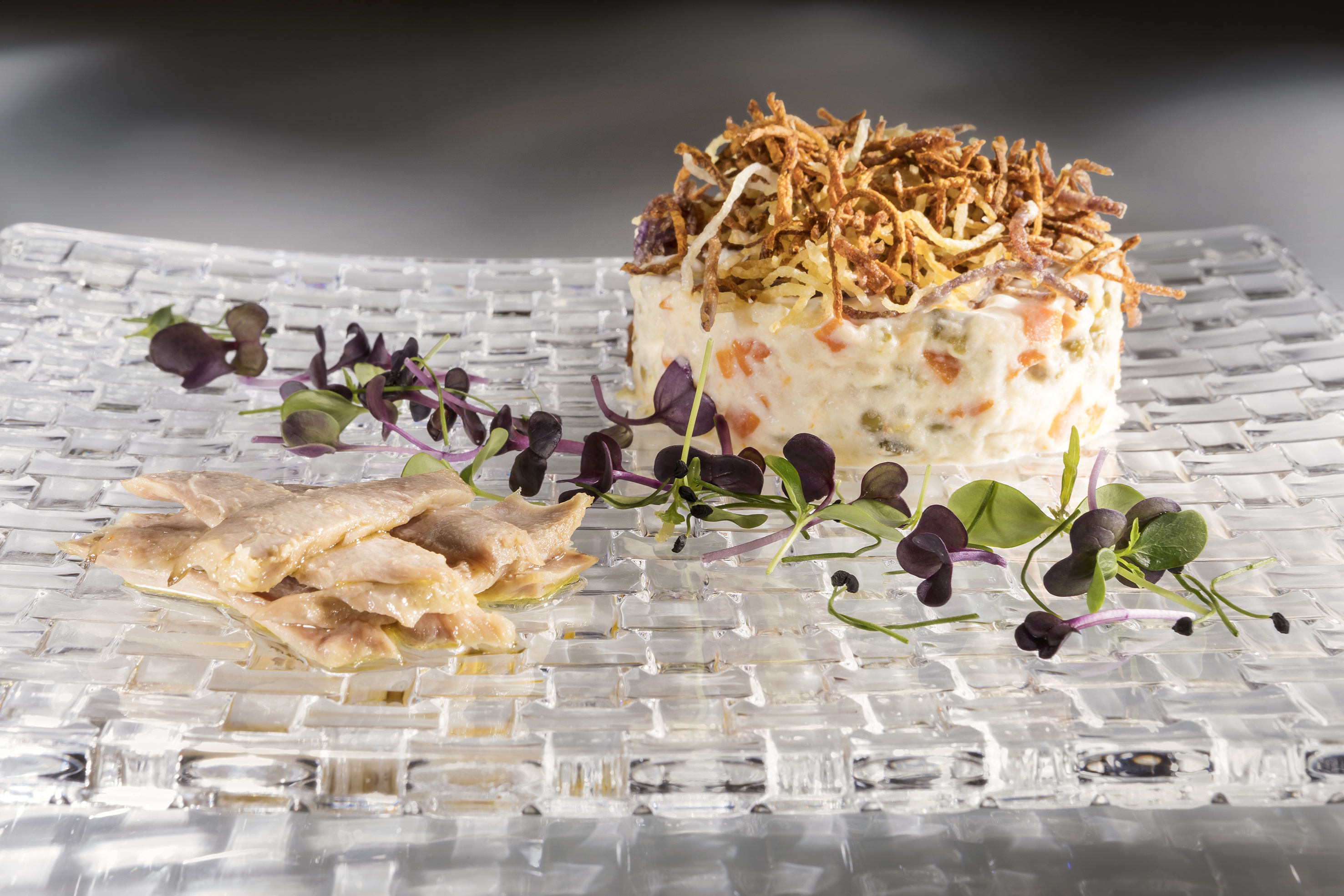 Spanish Ensaladilla Rusa, crispy potato, marinated fish, microgreens.