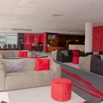 a large room with couches and red walls
