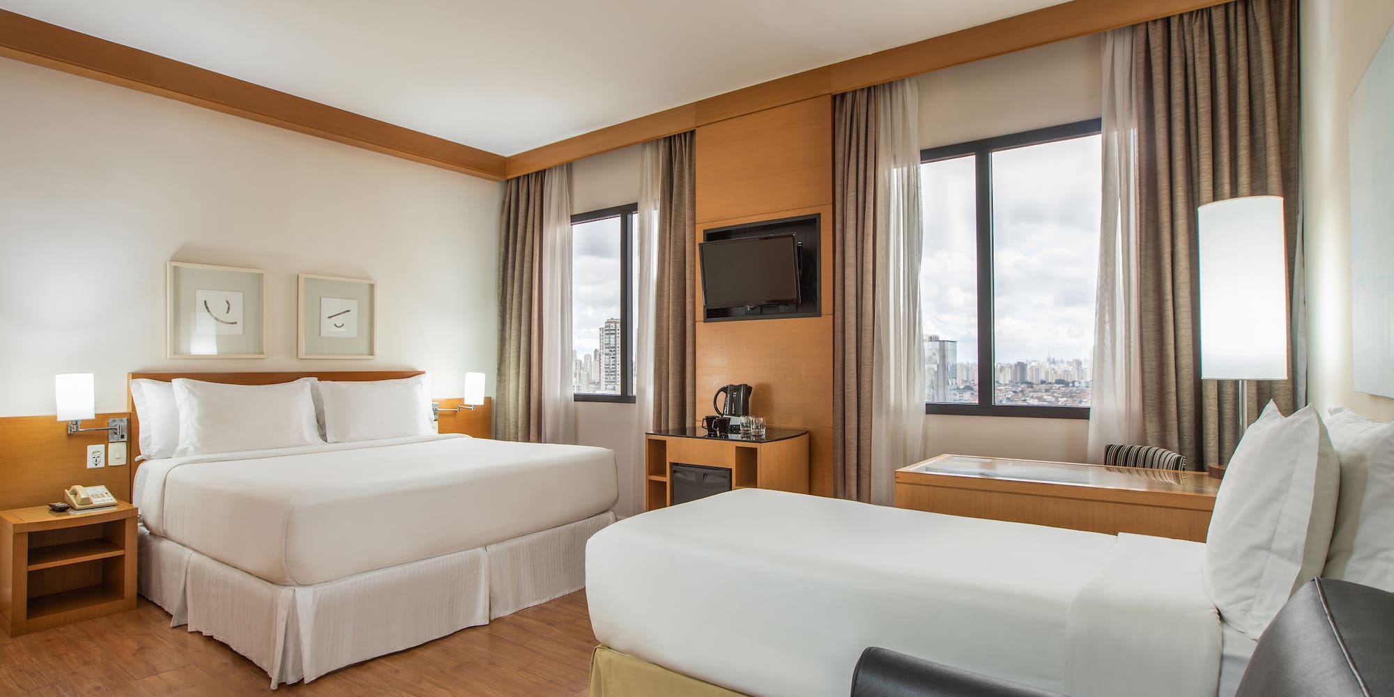 a room with two beds and a television