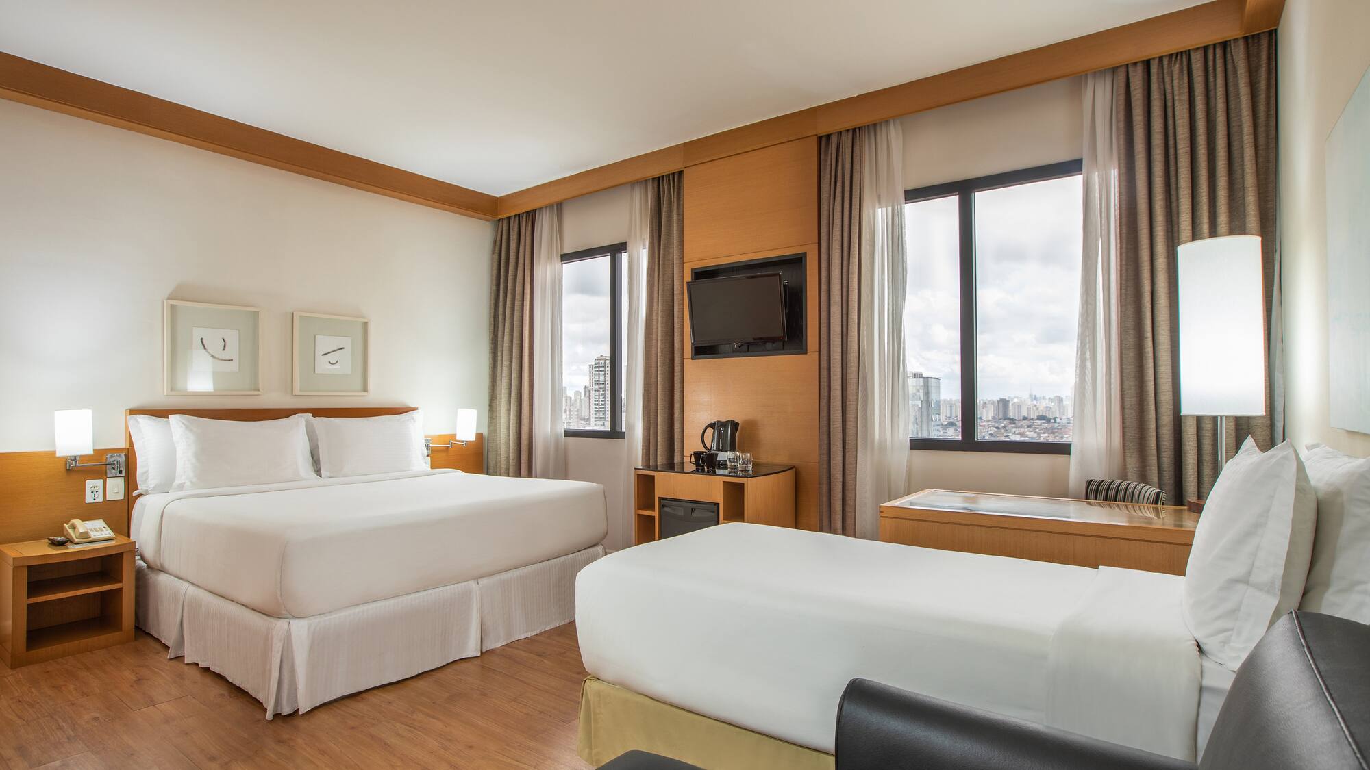 a room with two beds and a television