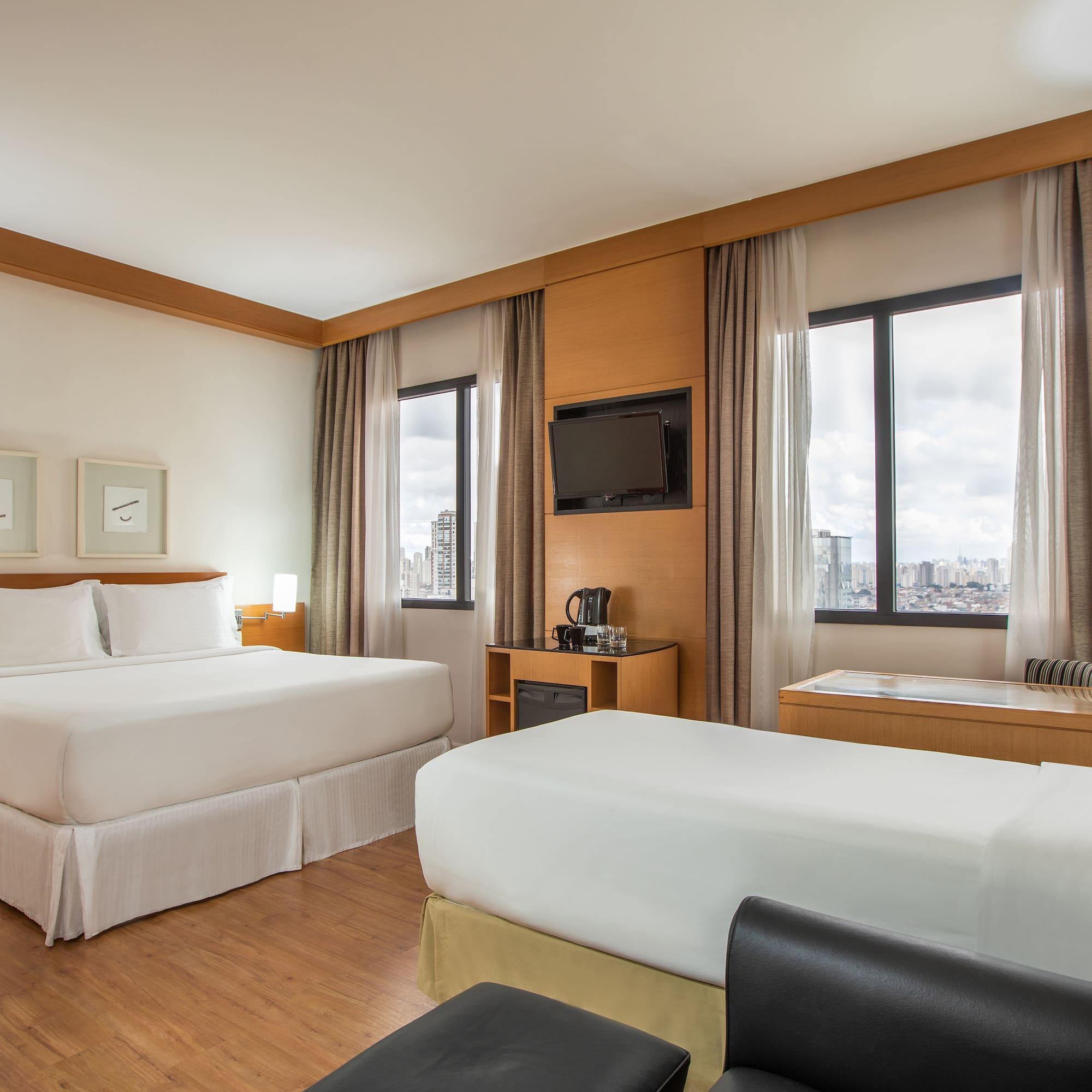 a room with two beds and a television