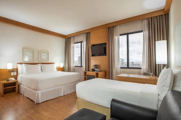 a room with two beds and a television