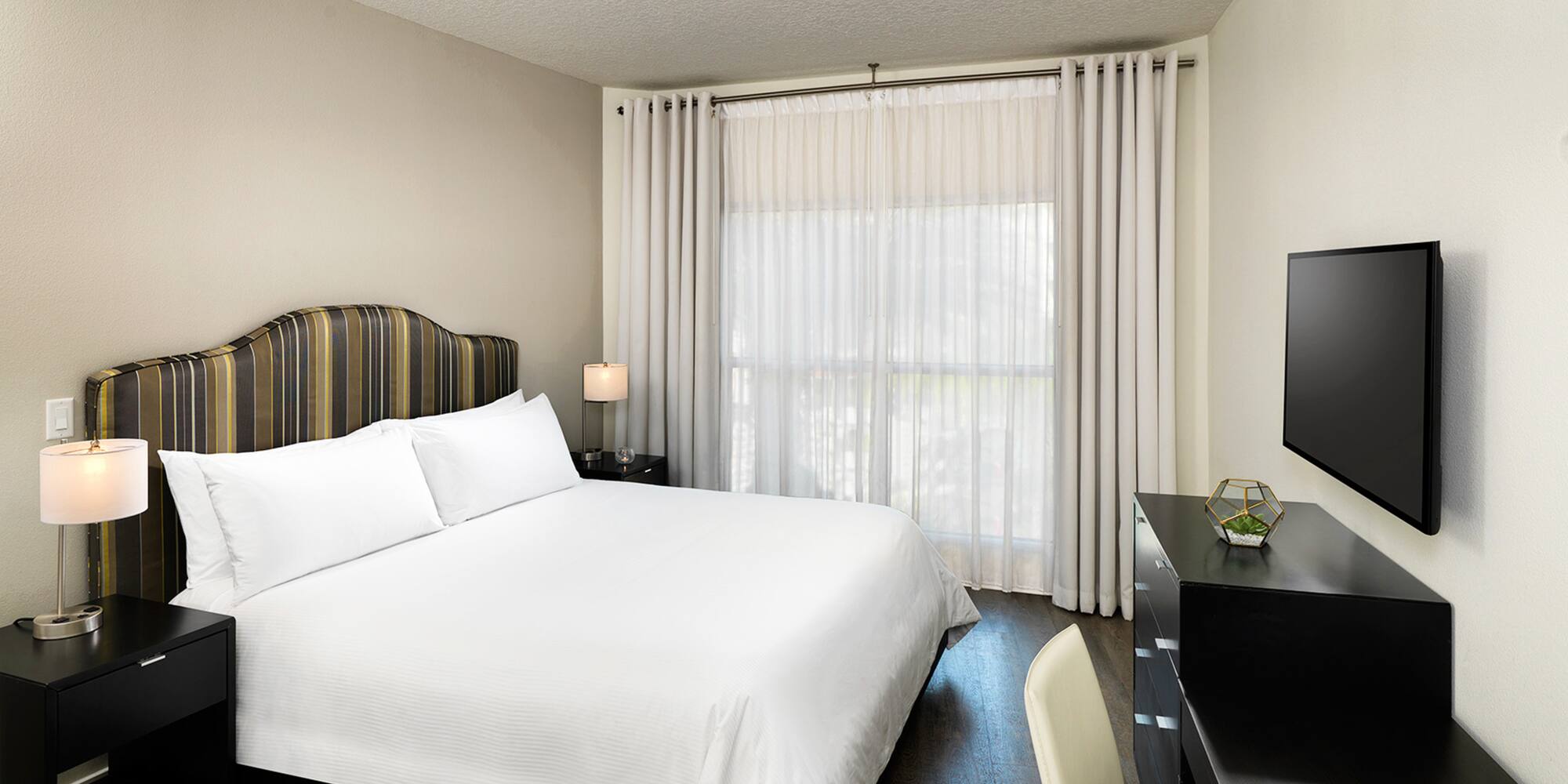 a bedroom with a bed and a desk