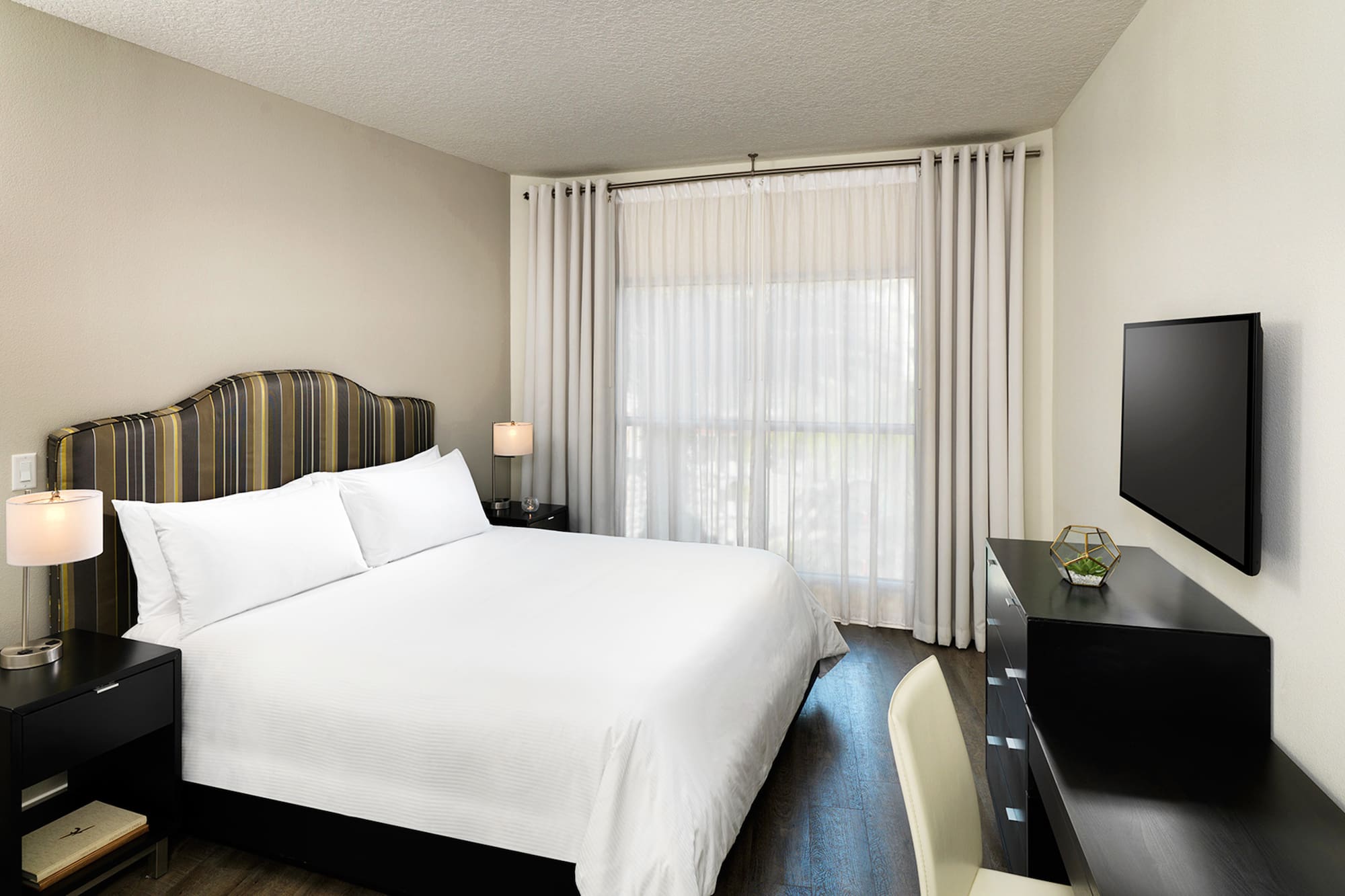 a bedroom with a bed and a desk