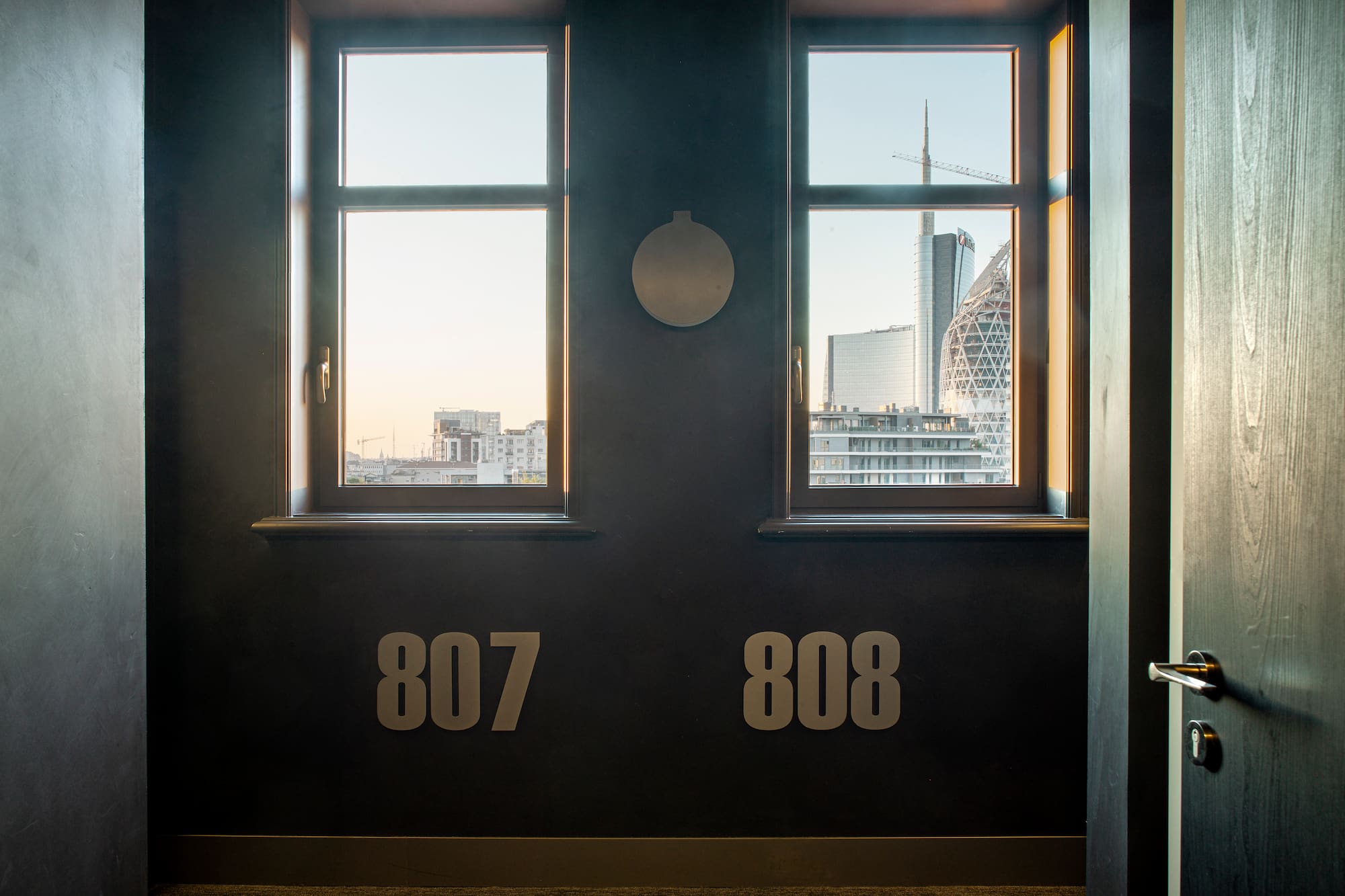 a room with two windows and a city view