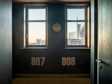 a room with two windows and a city view