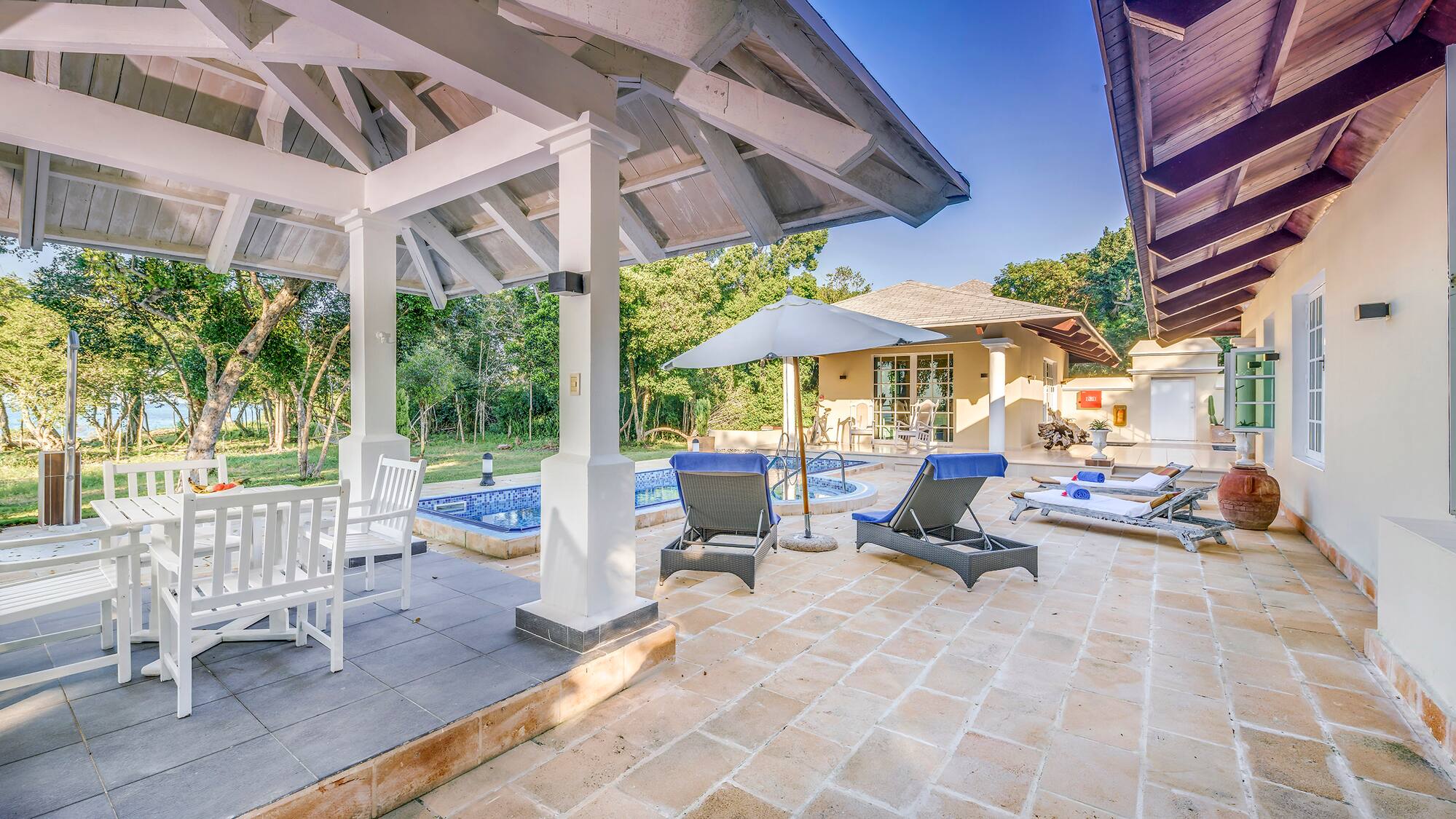 a patio with chairs and a pool