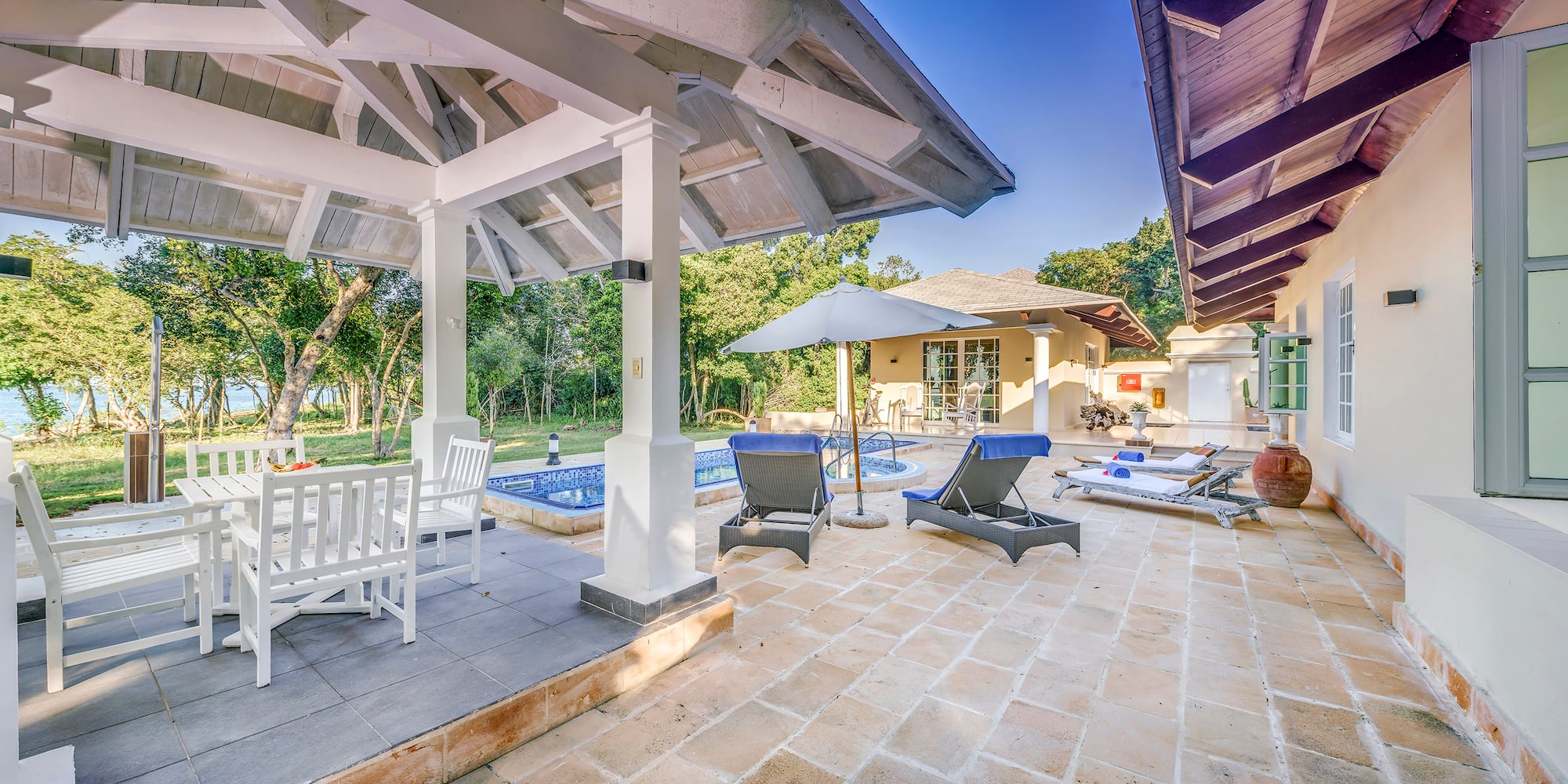 a patio with chairs and a pool