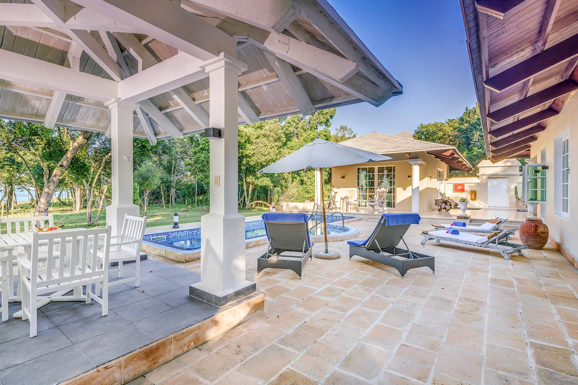 a patio with chairs and a pool