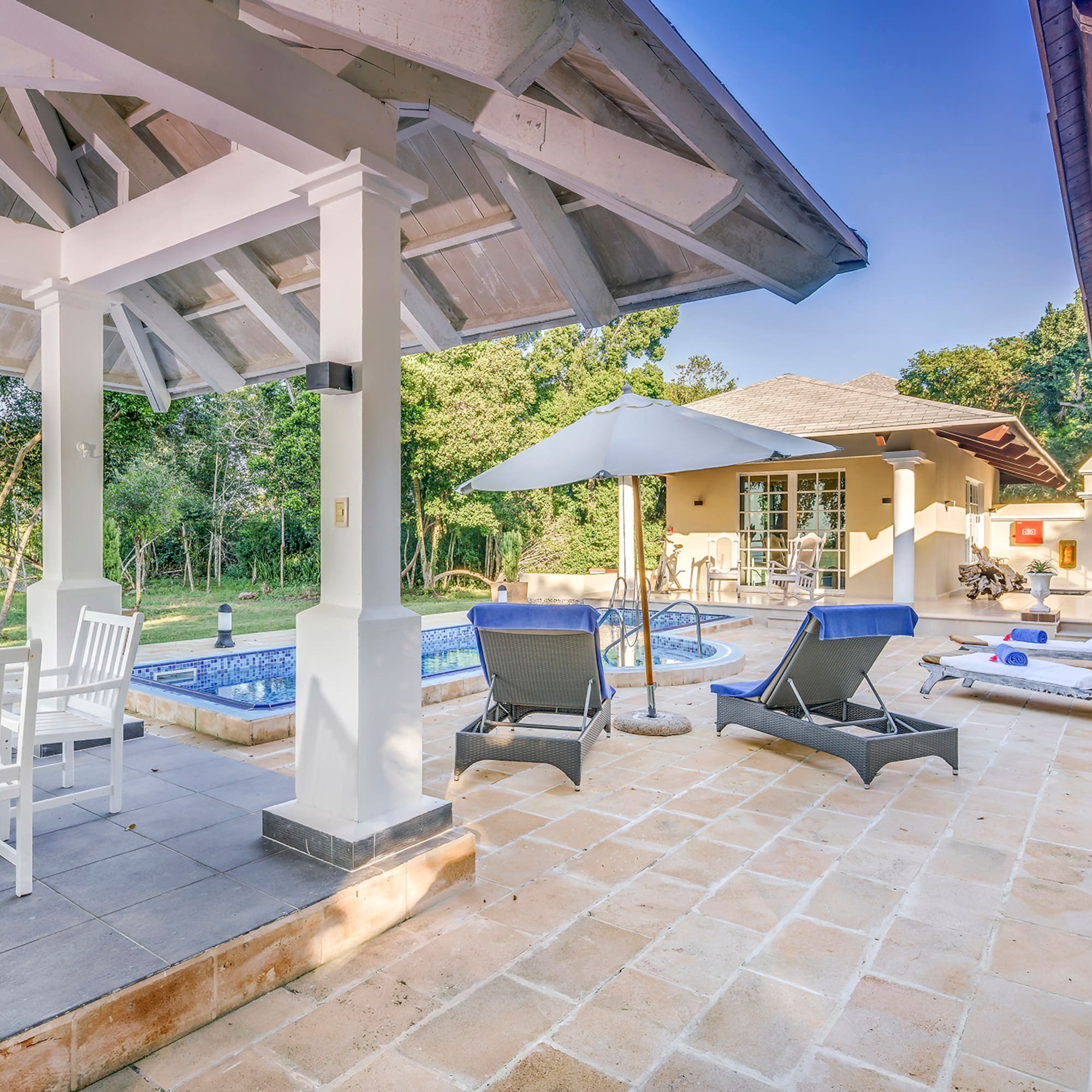 a patio with chairs and a pool