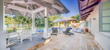 a patio with chairs and a pool