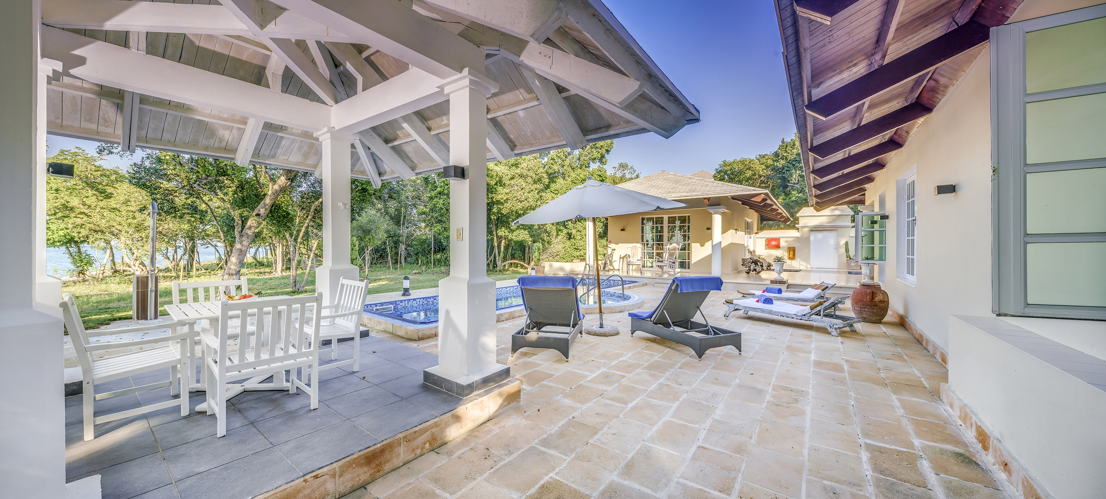 a patio with chairs and a pool