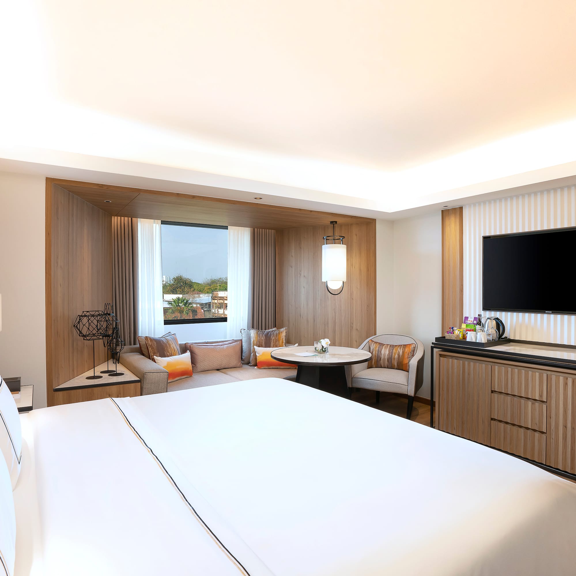 a room with a bed and a television