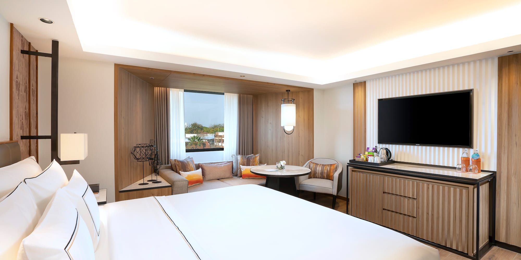 a room with a bed and a television