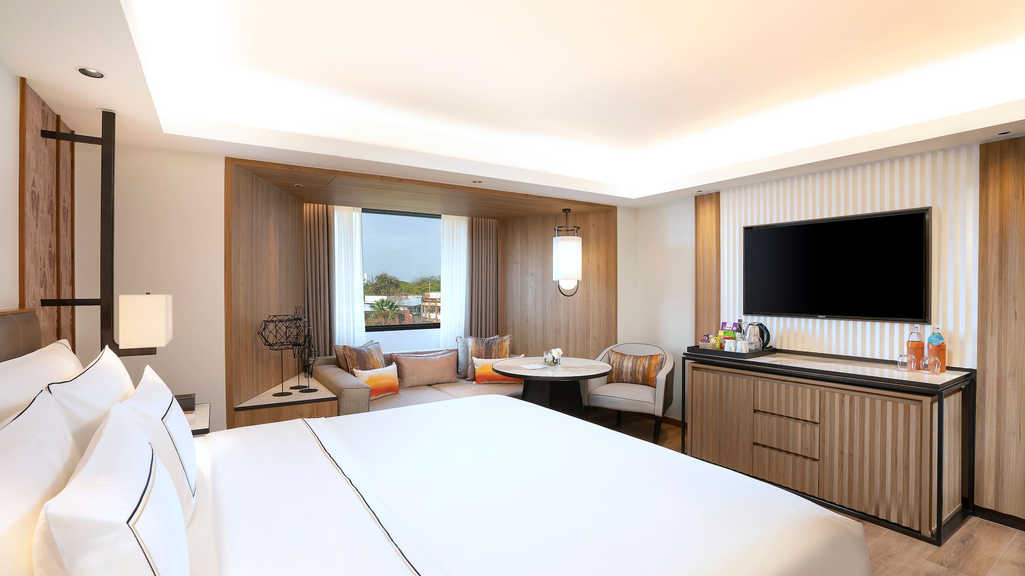 a room with a bed and a television