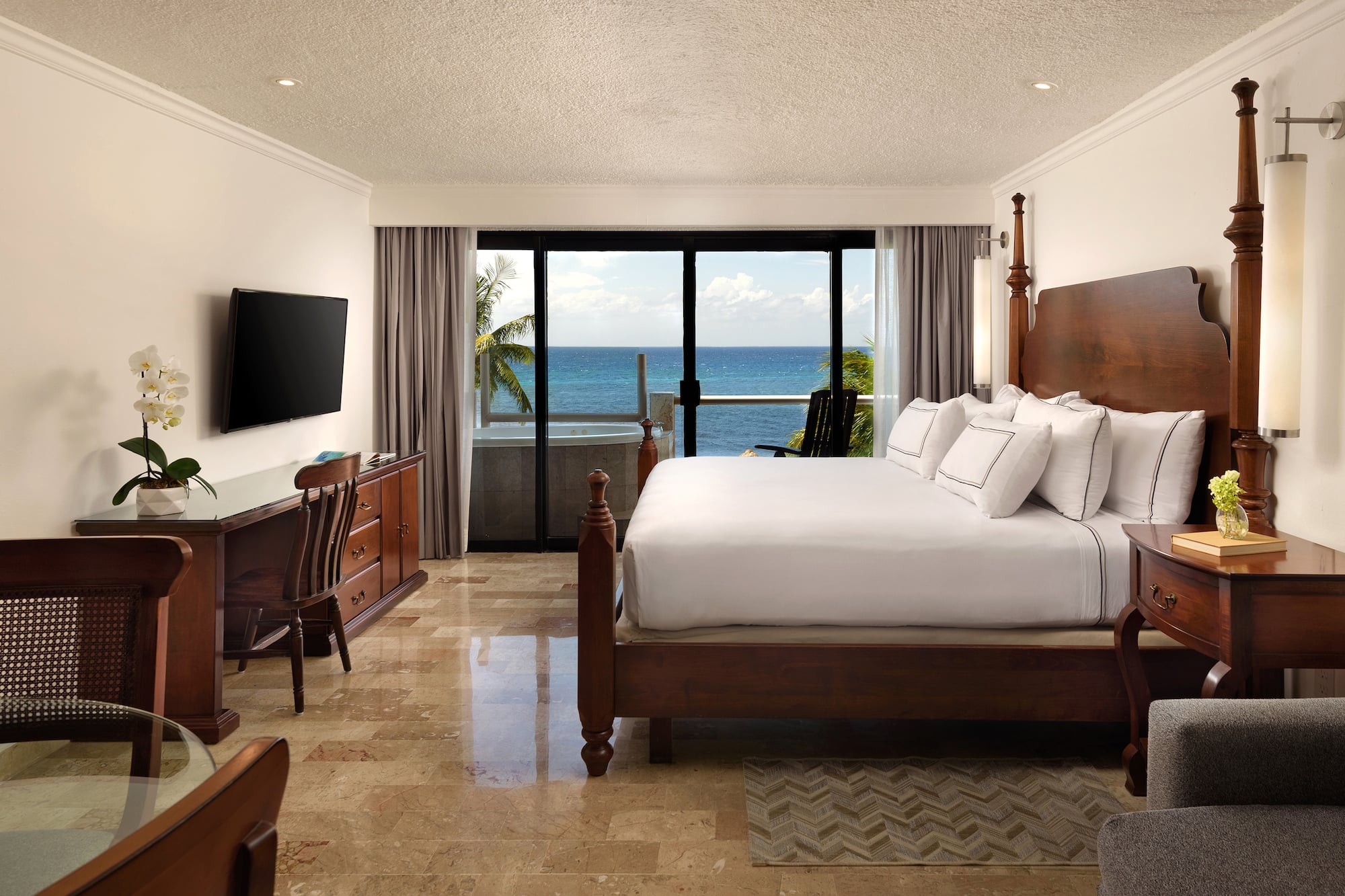 a bedroom with a large bed and a television