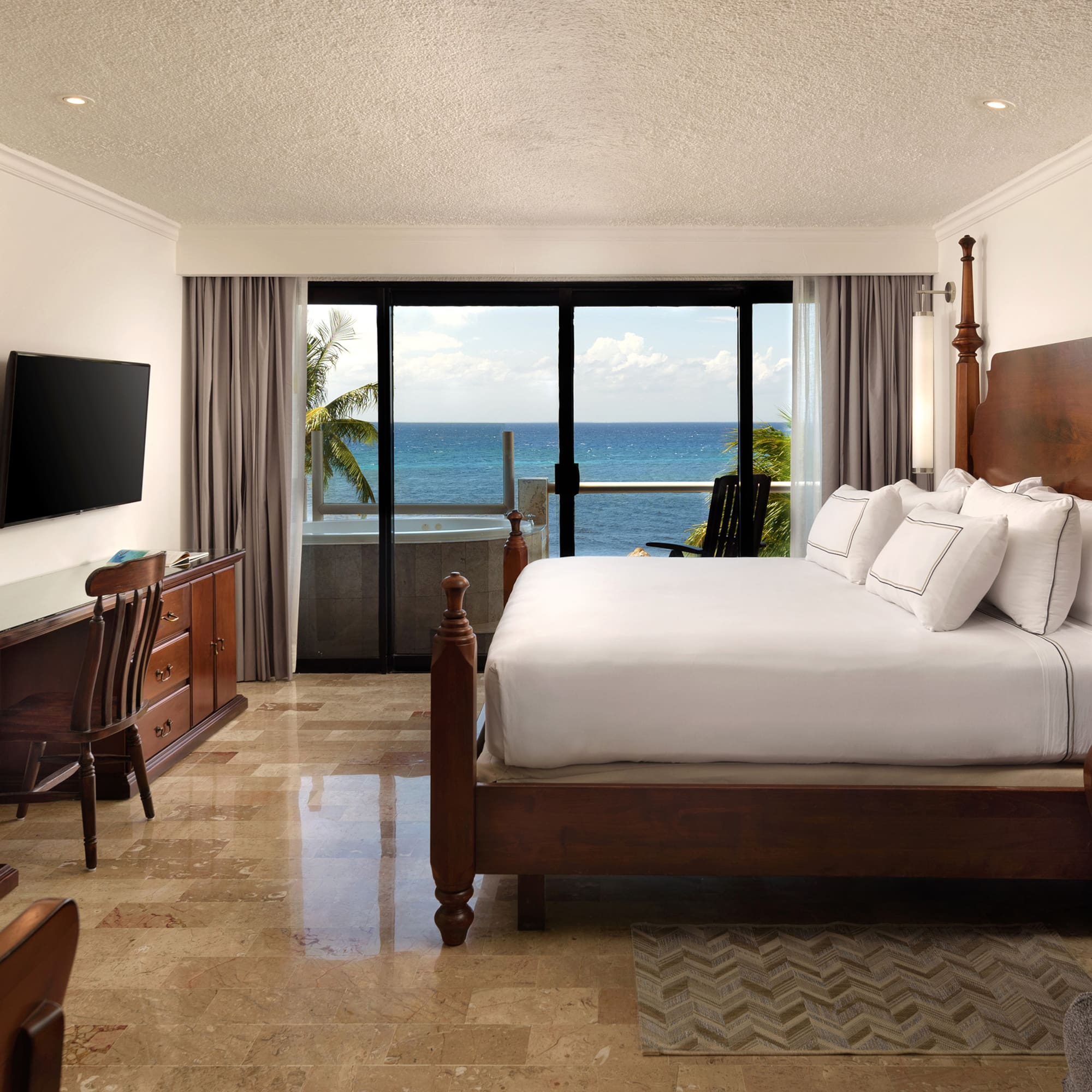 a bedroom with a large bed and a television