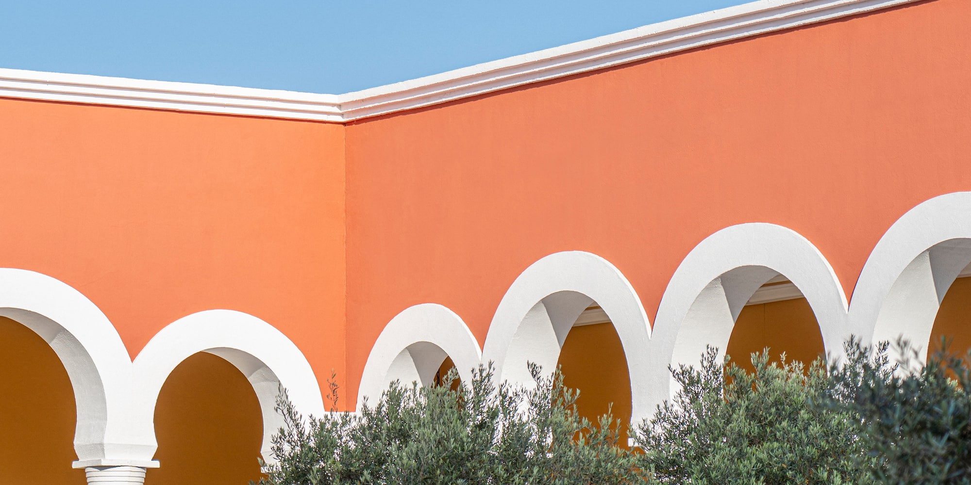 a building with arches and trees