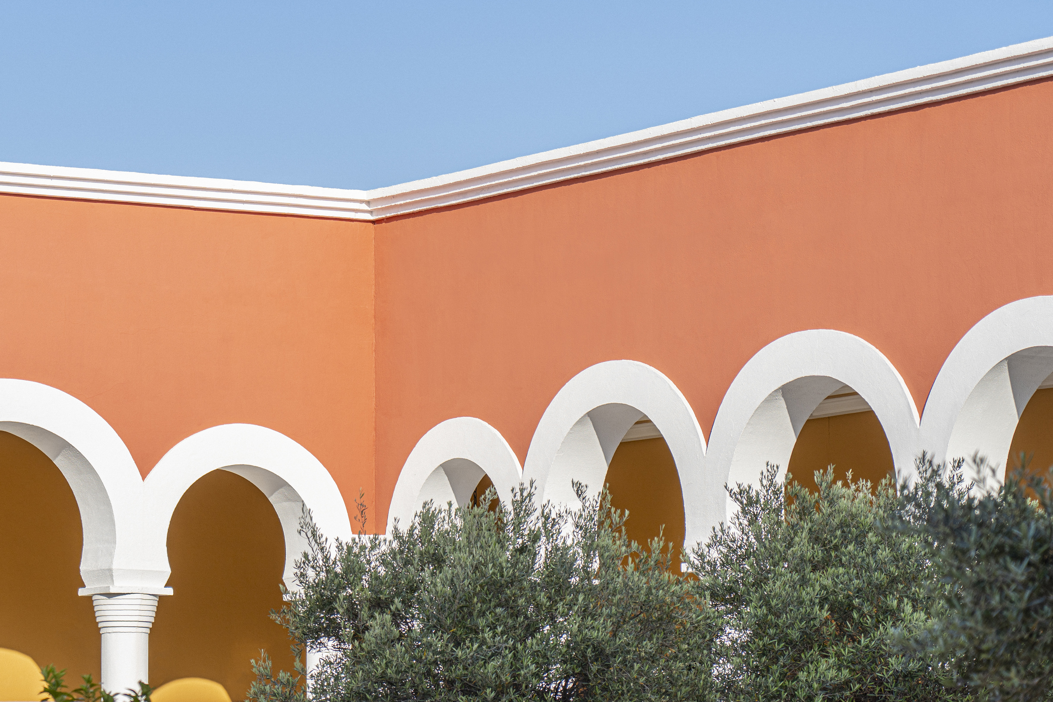 a building with arches and trees