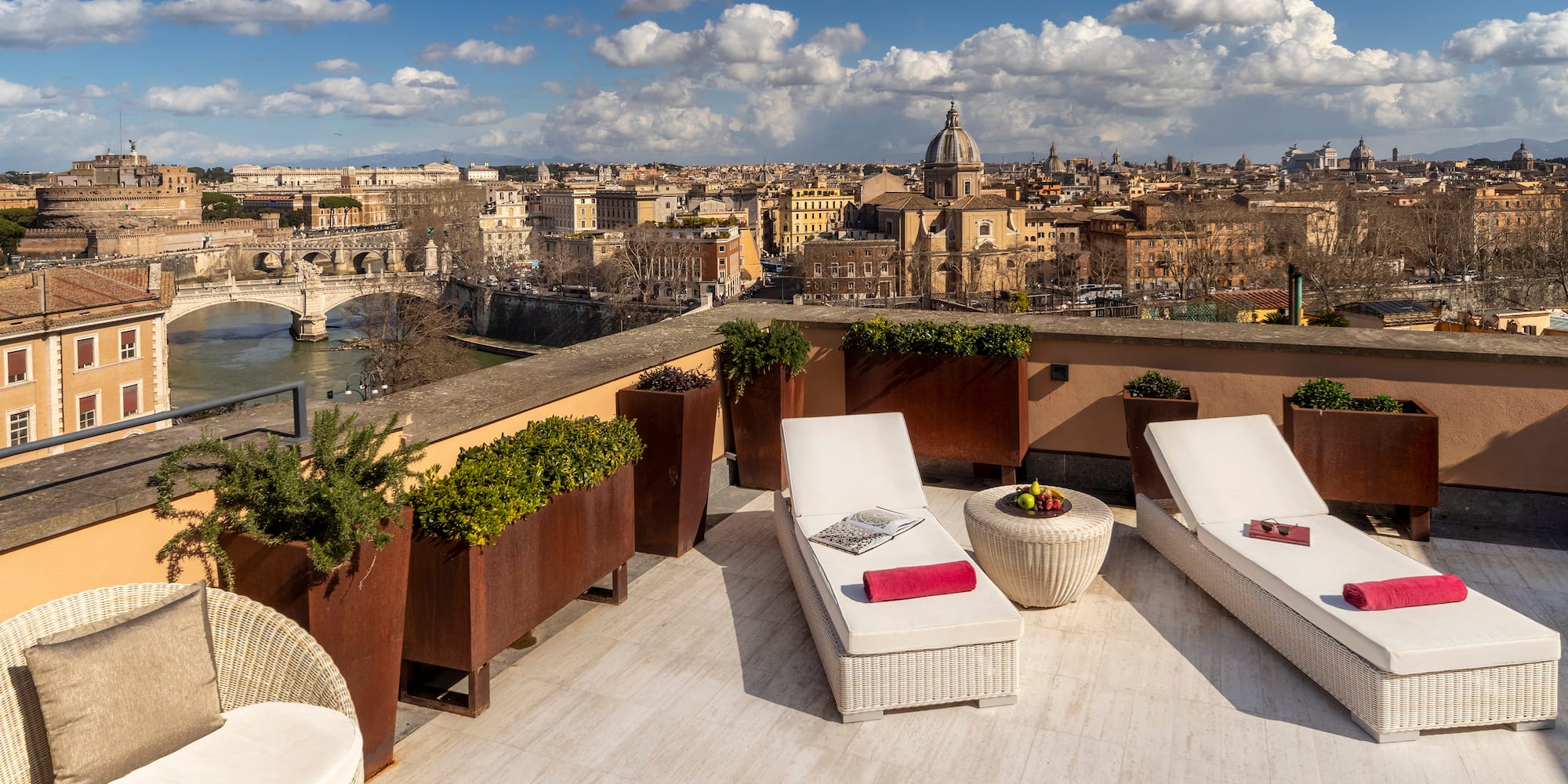 a deck with chairs and plants on it