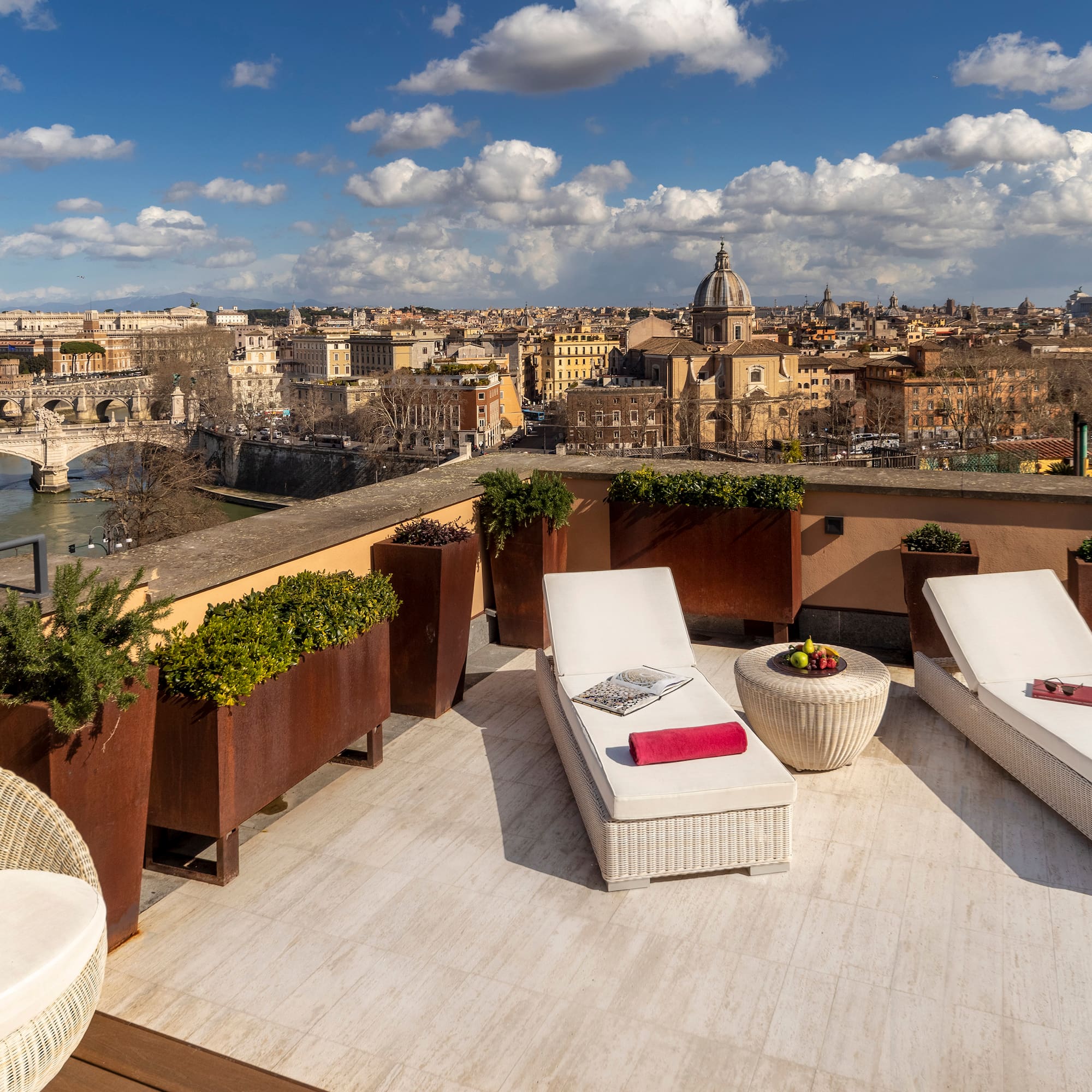 a deck with chairs and plants on it