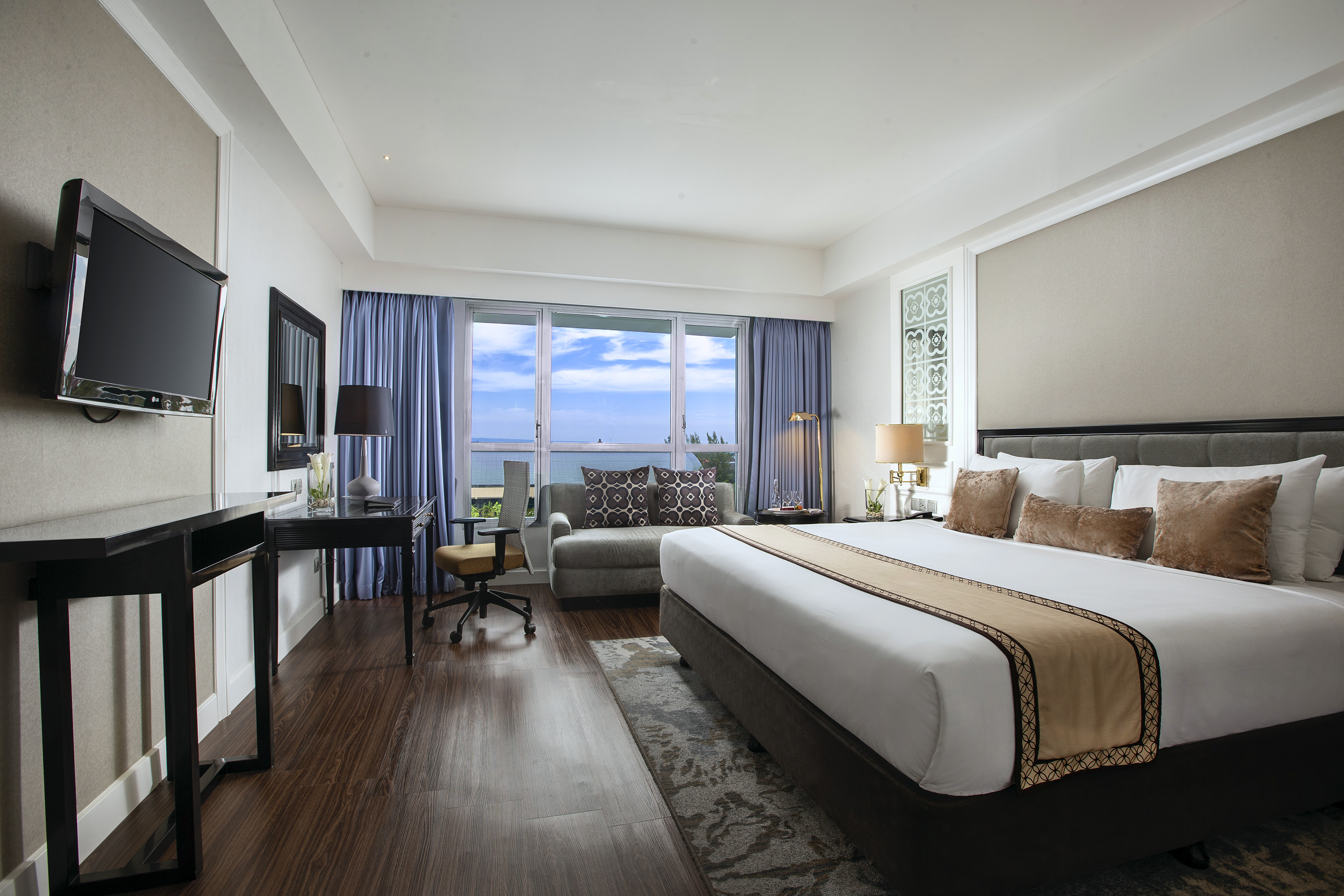 a room with a bed and a desk and a chair