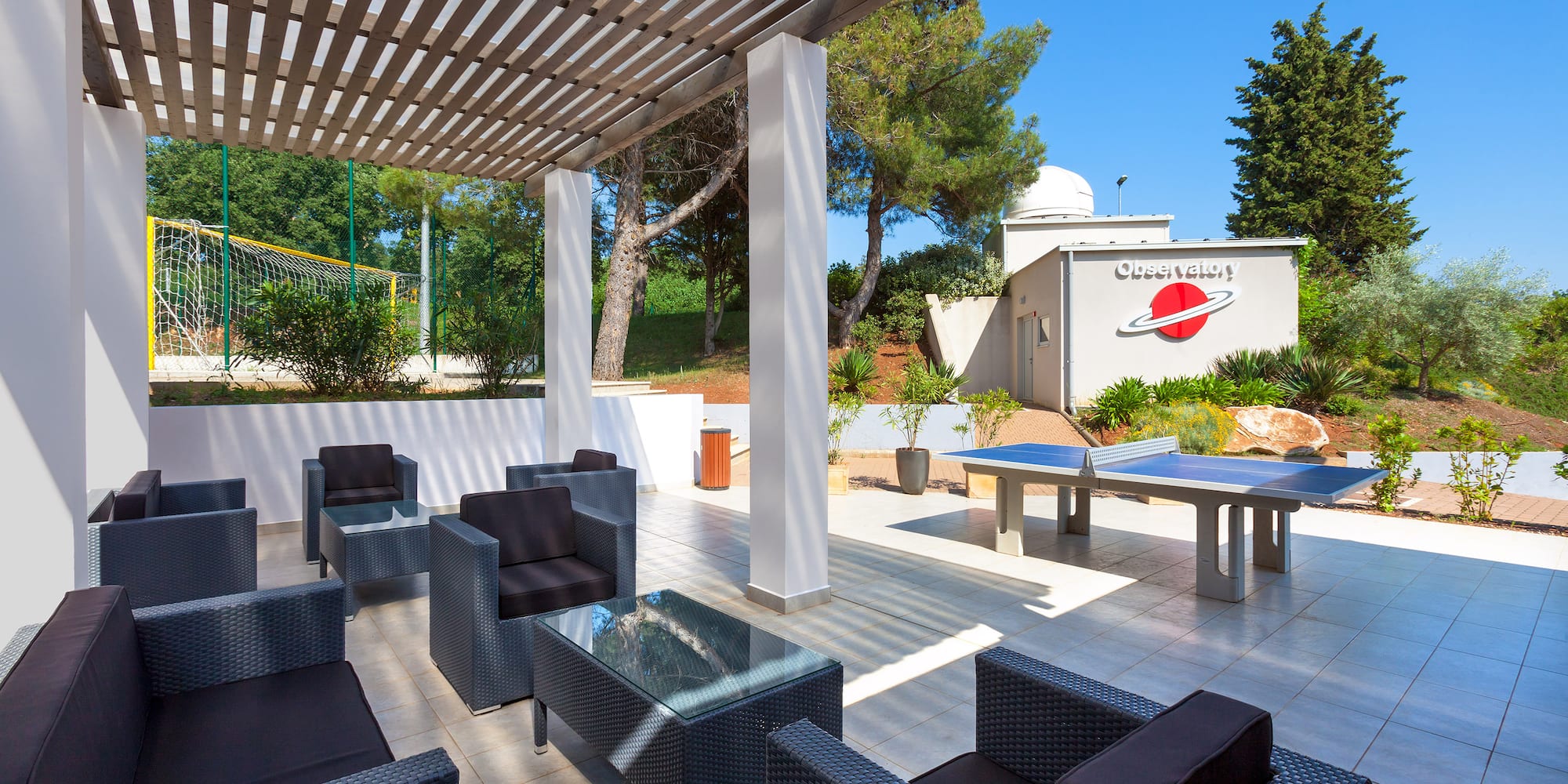 a table tennis table and chairs on a patio