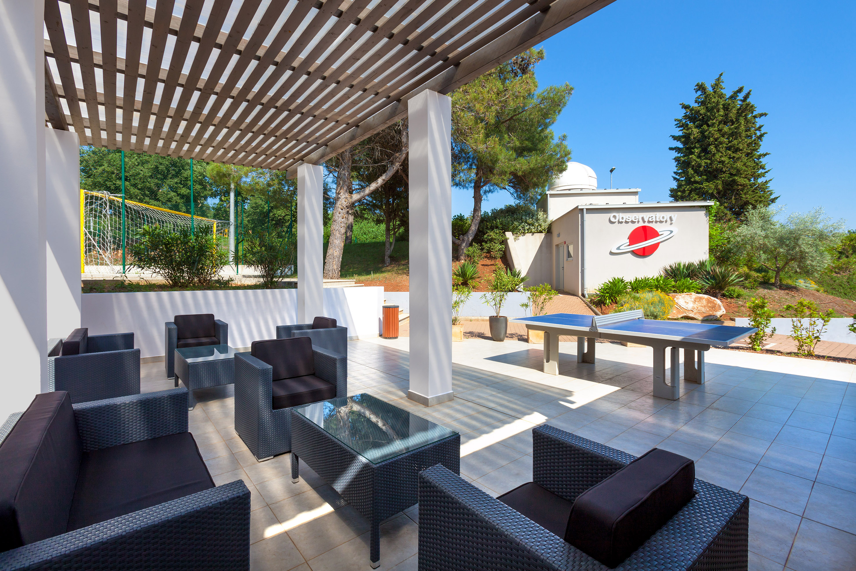 a table tennis table and chairs on a patio