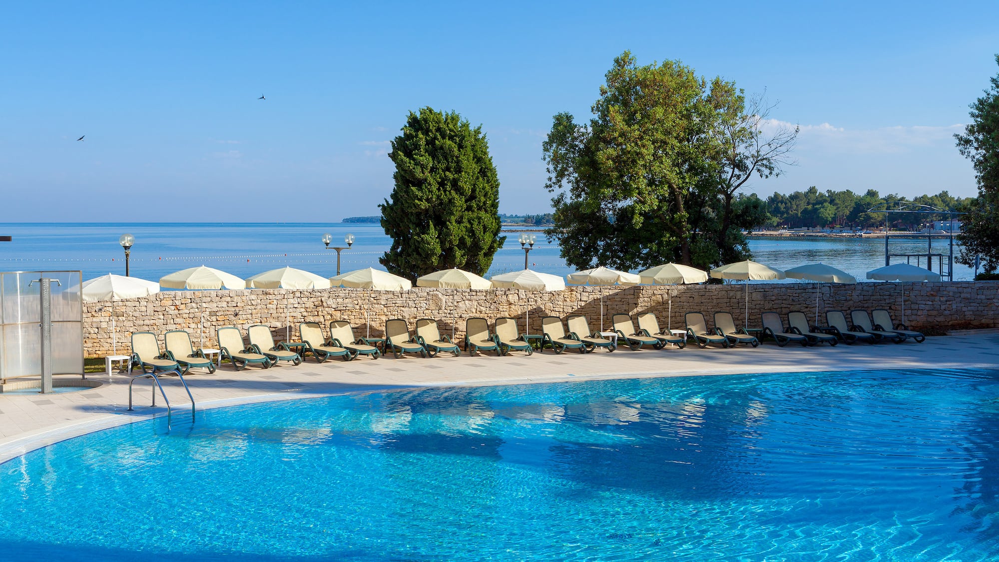 a pool with chairs and umbrellas