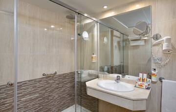 a bathroom with a shower and sink