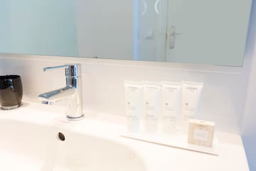 a bathroom sink with a faucet and a faucet and a few white tubes