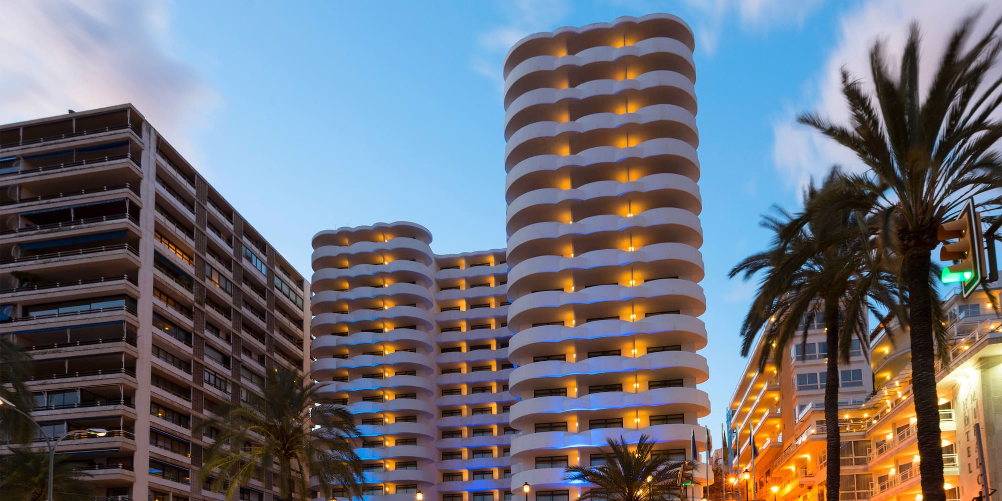 a street with palm trees and buildings