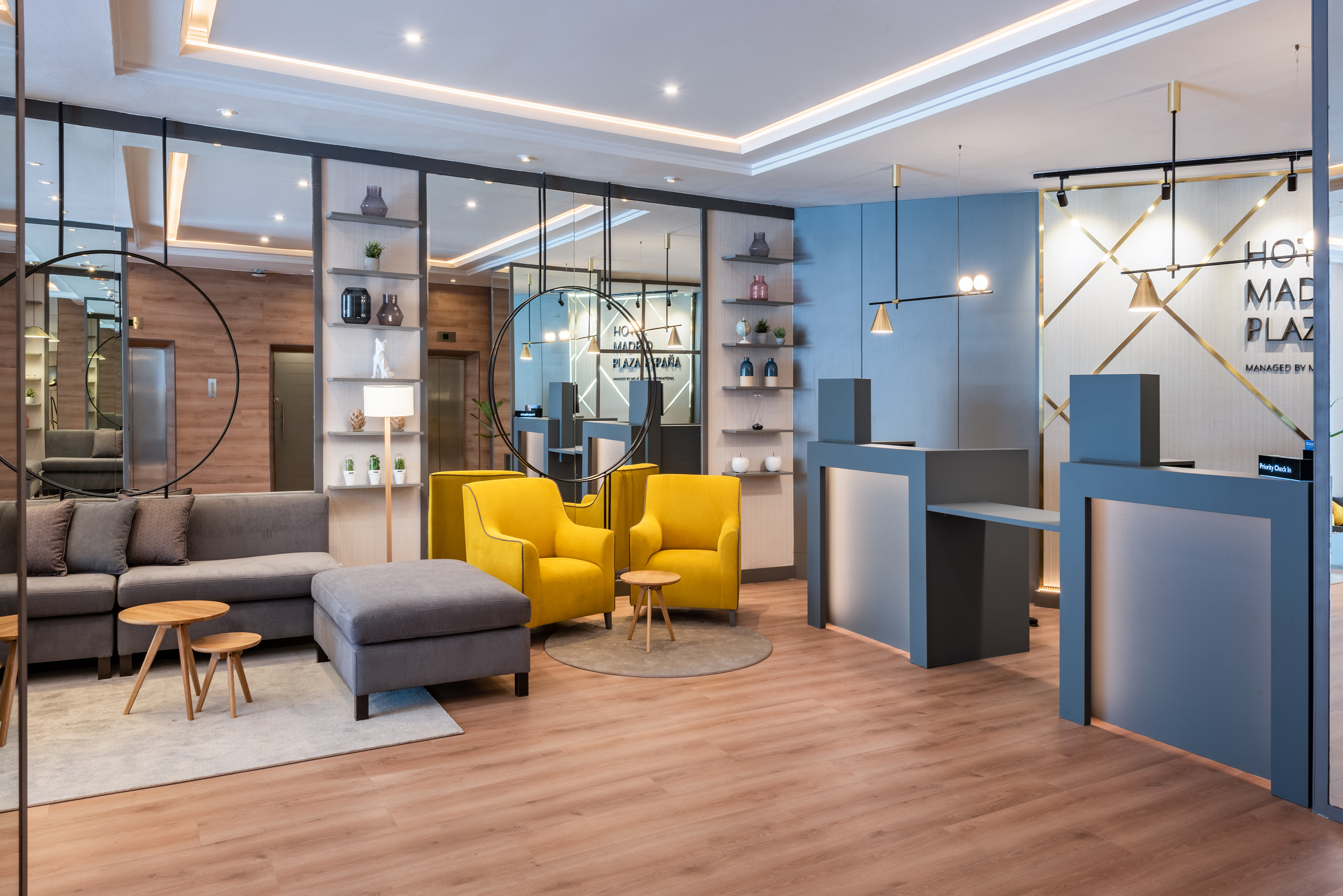 a room with a reception desk and yellow chairs