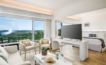 a living room with a television and chairs
