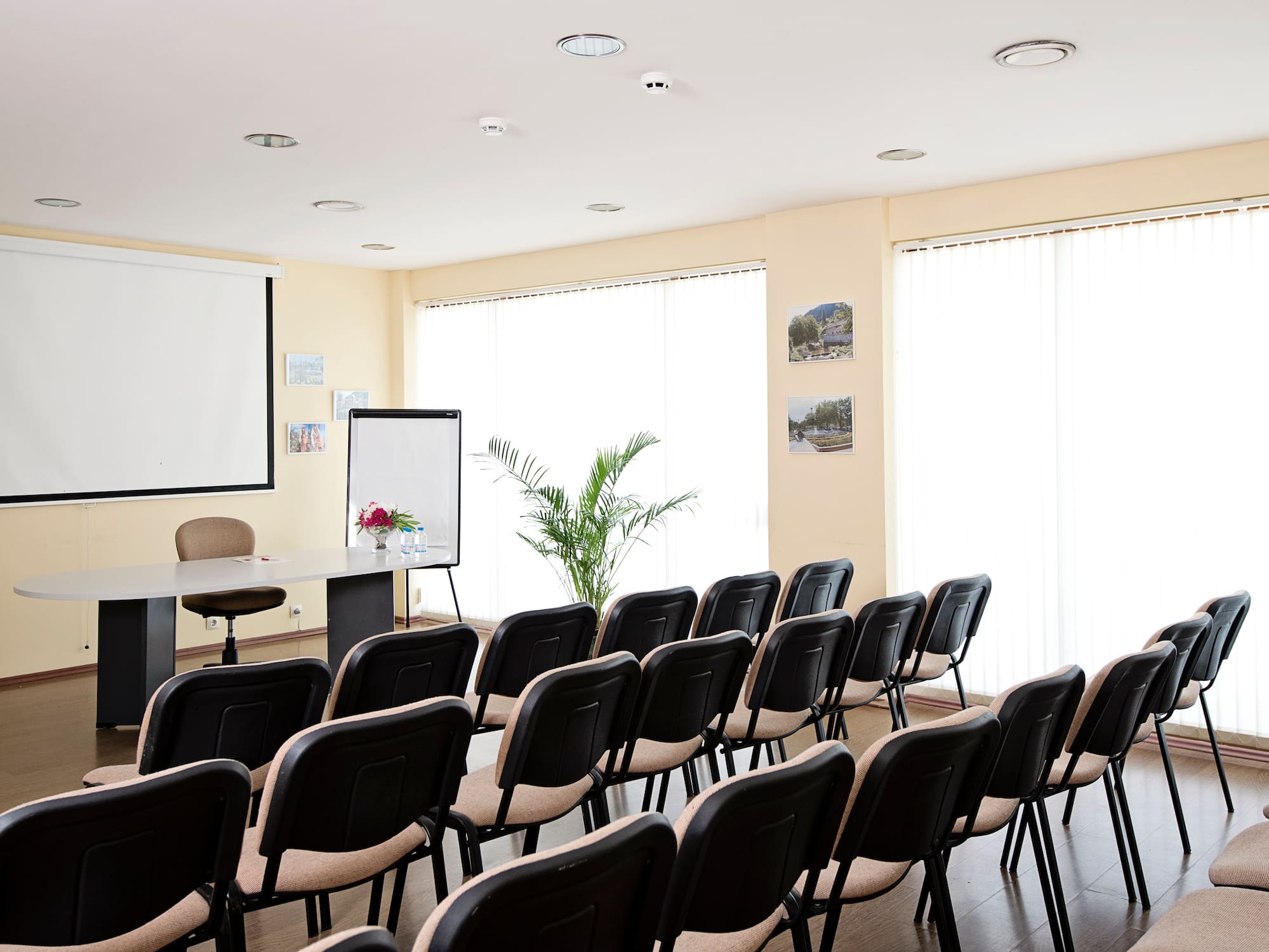 a room with chairs and a projector screen